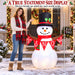 G128 5FT inflatable Christmas snowman with top hat, red scarf and Let It Snow banner lit up in a yard