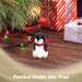 G128 resin penguin statue holding a light-up LED star, 5 inch tabletop holiday figurine