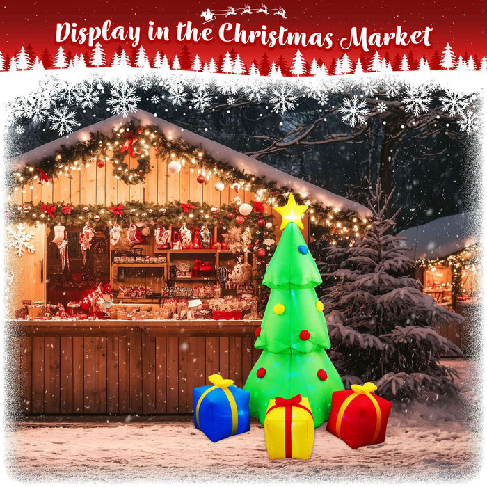 G128 7FT inflatable Christmas tree with three gift boxes and built-in LED lights lit up in a yard