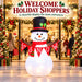 G128 5FT inflatable Christmas snowman with top hat, red scarf and Let It Snow banner lit up in a yard