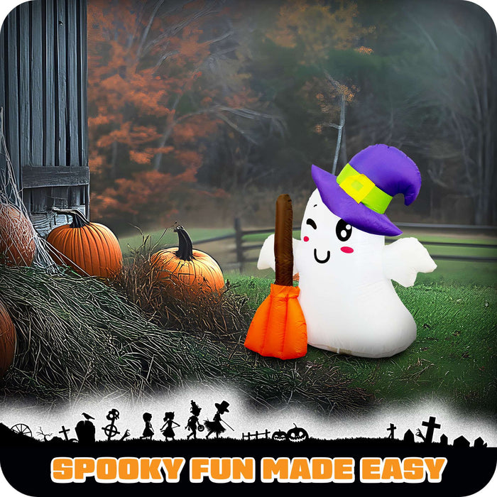 G128 3.5FT inflatable Halloween ghost in a witch hat holding a broom, glowing on a front porch