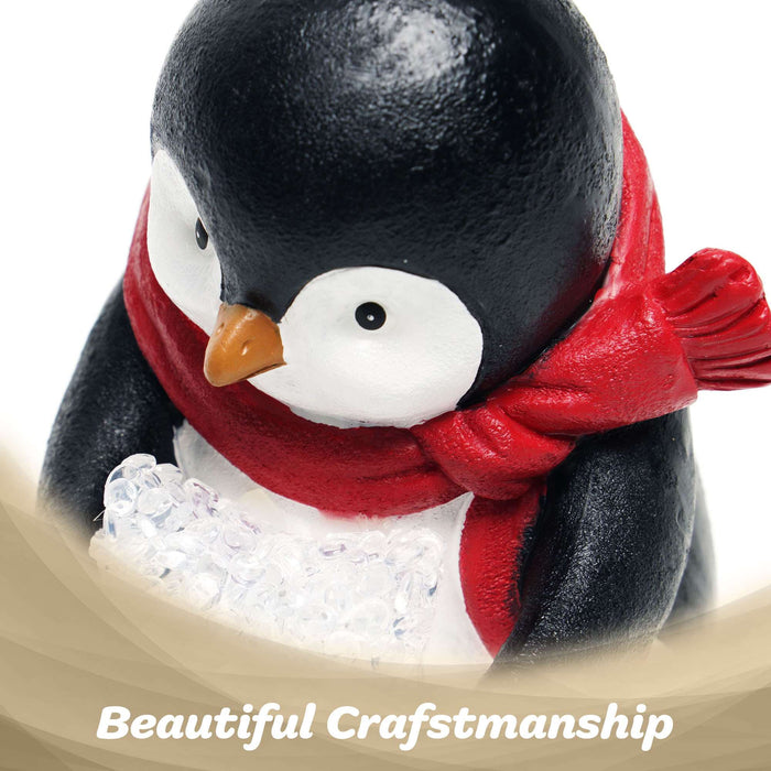 G128 resin penguin statue holding a light-up LED star, 5 inch tabletop holiday figurine