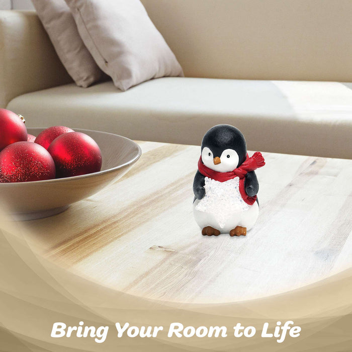 G128 resin penguin statue holding a light-up LED star, 5 inch tabletop holiday figurine
