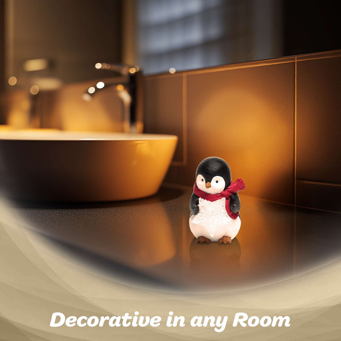 G128 resin penguin statue holding a light-up LED star, 5 inch tabletop holiday figurine